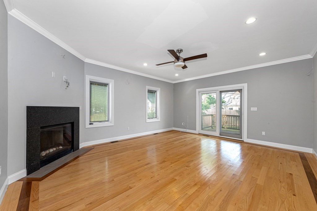 31 Knoll Street Boston, MA 02131 - Photo 19 of 34 a view of empty room with wooden floor and fireplace