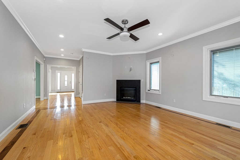 31 Knoll Street Boston, MA 02131 - Photo 20 of 34 a view of empty room with wooden floor and ceiling fan