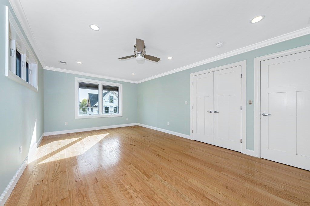 31 Knoll Street Boston, MA 02131 - Photo 22 of 34 a view of empty room with wooden floor and fan