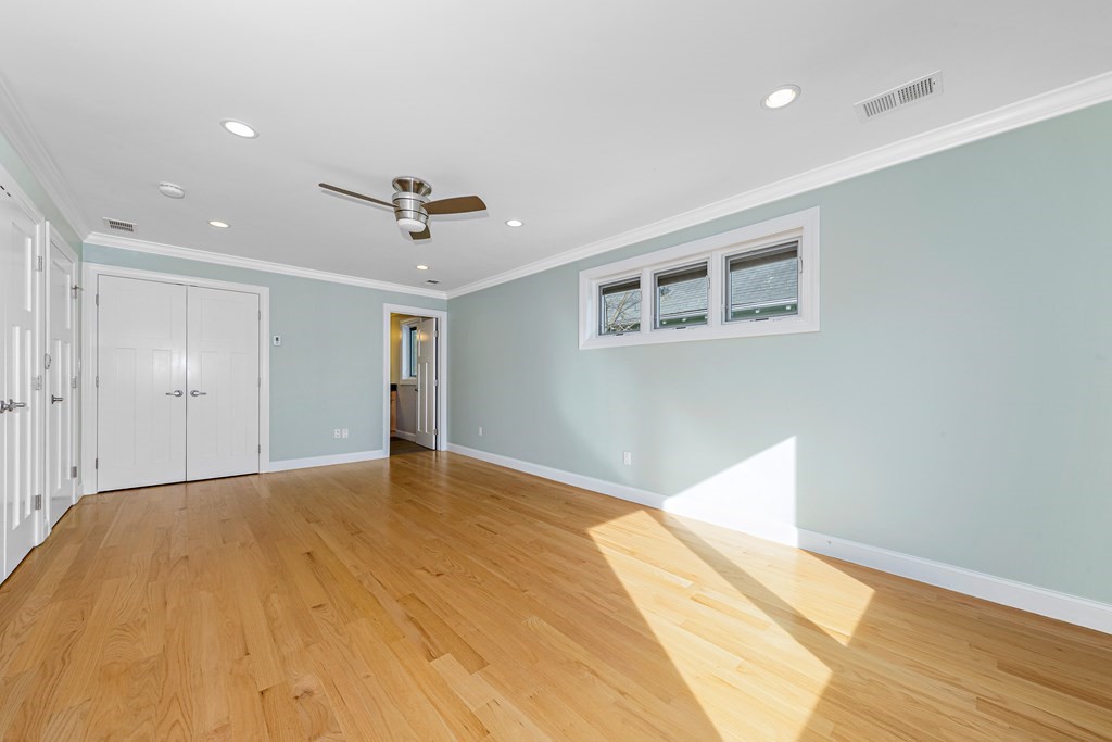 31 Knoll Street Boston, MA 02131 - Photo 23 of 34 a view of empty room with wooden floor and fan