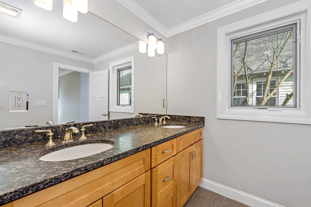 31 Knoll Street Boston, MA 02131 - Photo 25 of 34 a bathroom with a granite countertop sink and a mirror