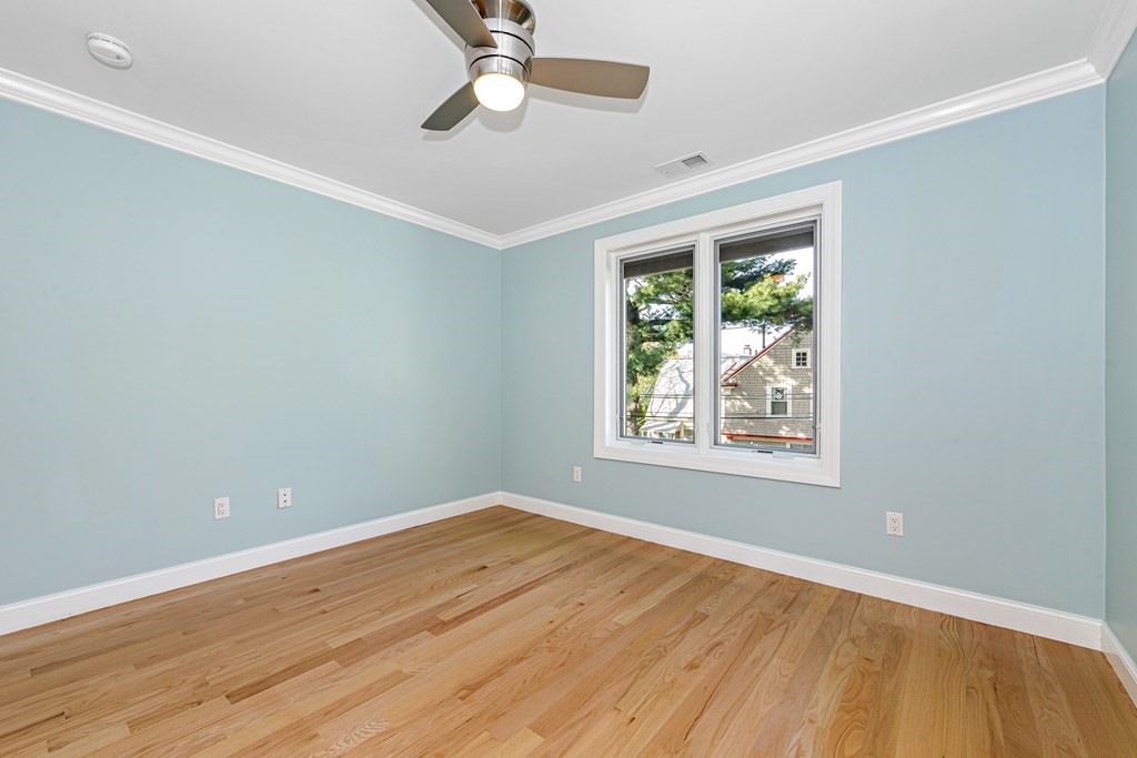 31 Knoll Street Boston, MA 02131 - Photo 29 of 34 a view of an empty room with wooden floor and a window