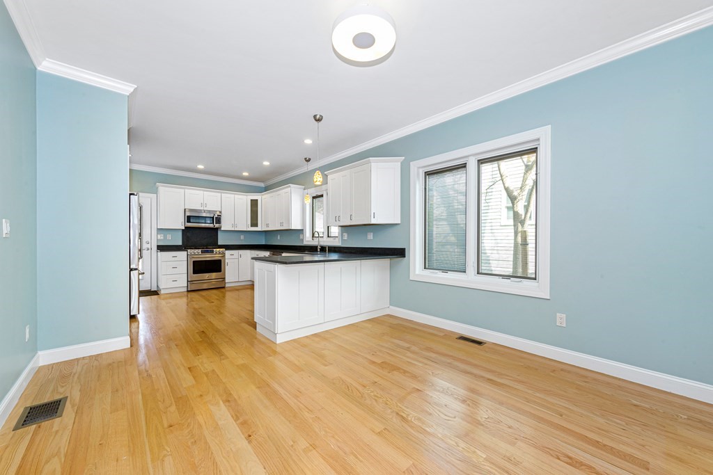 31 Knoll Street Boston, MA 02131 - Photo 10 of 34 a large kitchen with stainless steel appliances granite countertop a stove and a sink