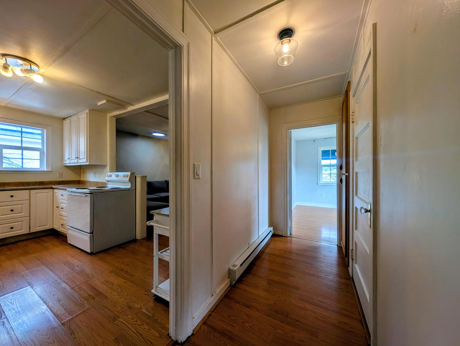 203 Market Street San Andreas, CA 95249 - Photo 22 of 54 a view of a hallway with wooden floor and a kitchen