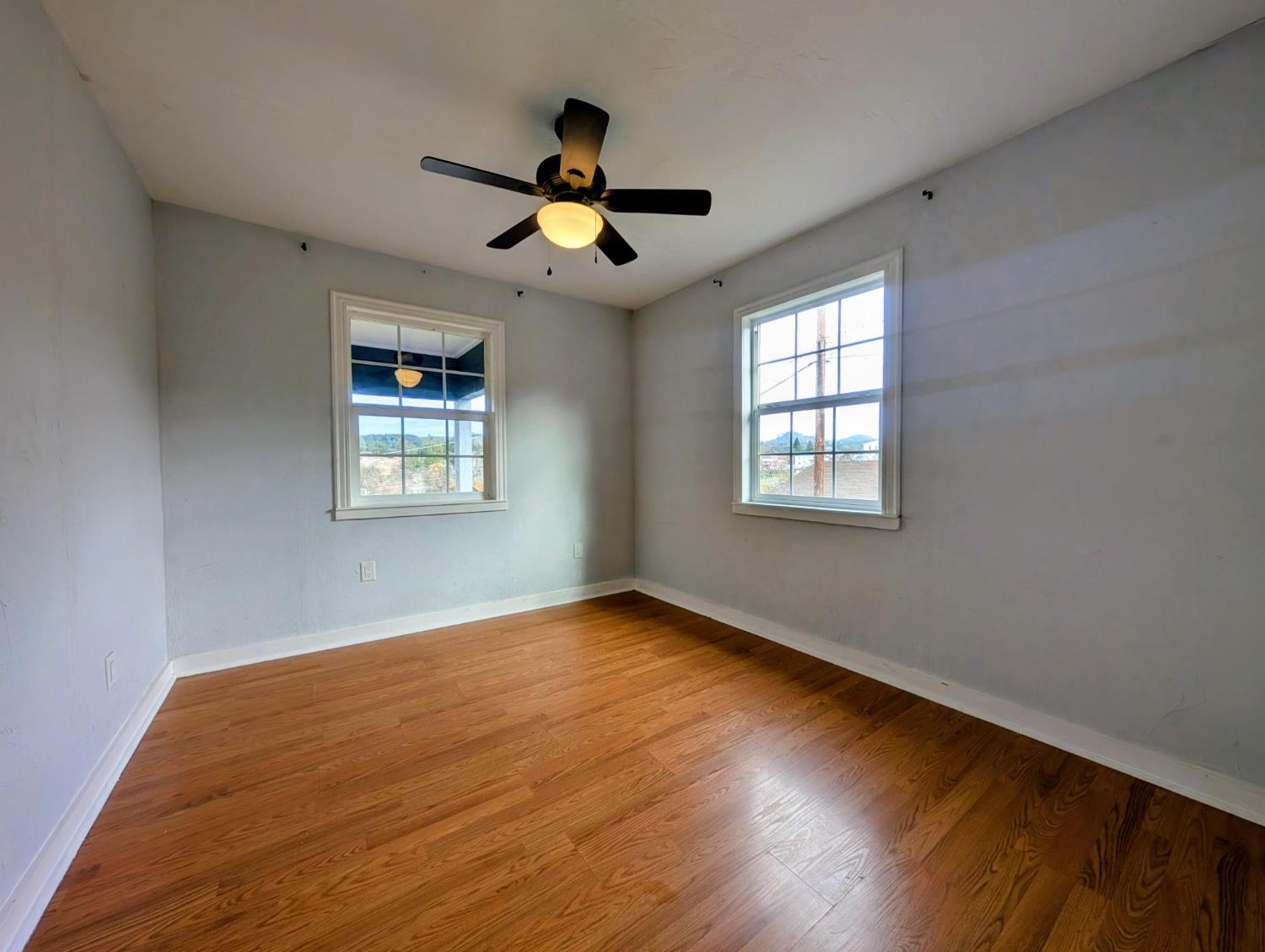 203 Market Street San Andreas, CA 95249 - Photo 23 of 54 a view of an empty room with wooden floor and a window
