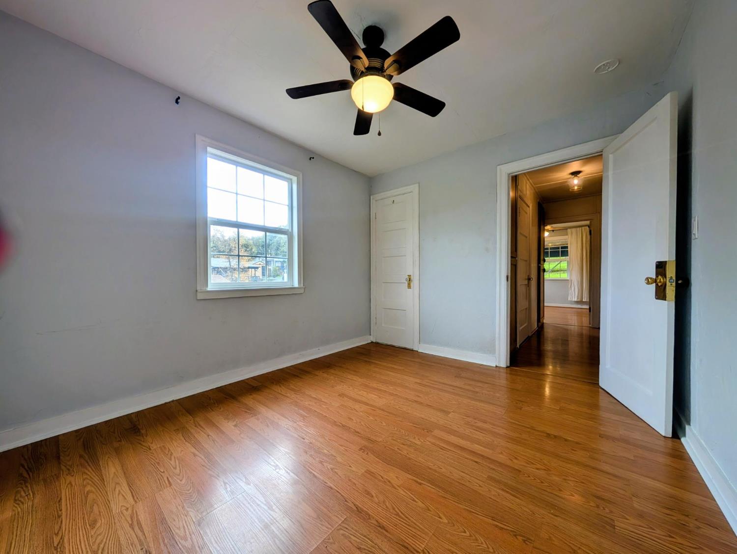 203 Market Street San Andreas, CA 95249 - Photo 24 of 54 a view of an empty room with window and wooden floor