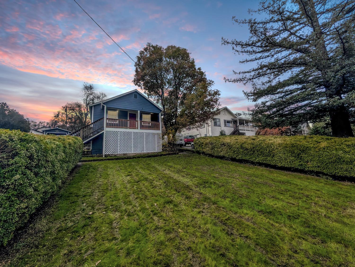203 Market Street San Andreas, CA 95249 - Photo 7 of 54 a front view of a house with a garden and yard