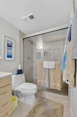 a bathroom with a toilet a sink and a shower