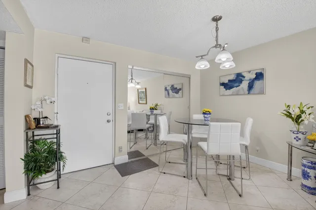 a view of a dining room with furniture and chandelier