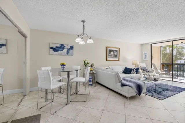 a living room with furniture and a chandelier