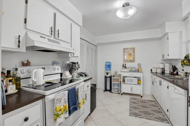 a kitchen with stainless steel appliances granite countertop a stove and a sink