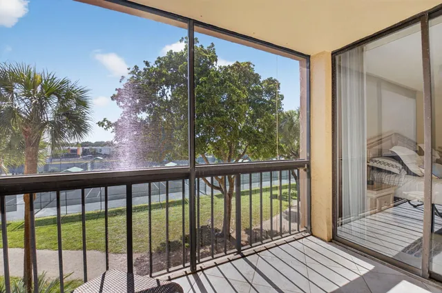 a view of a balcony with wooden floor