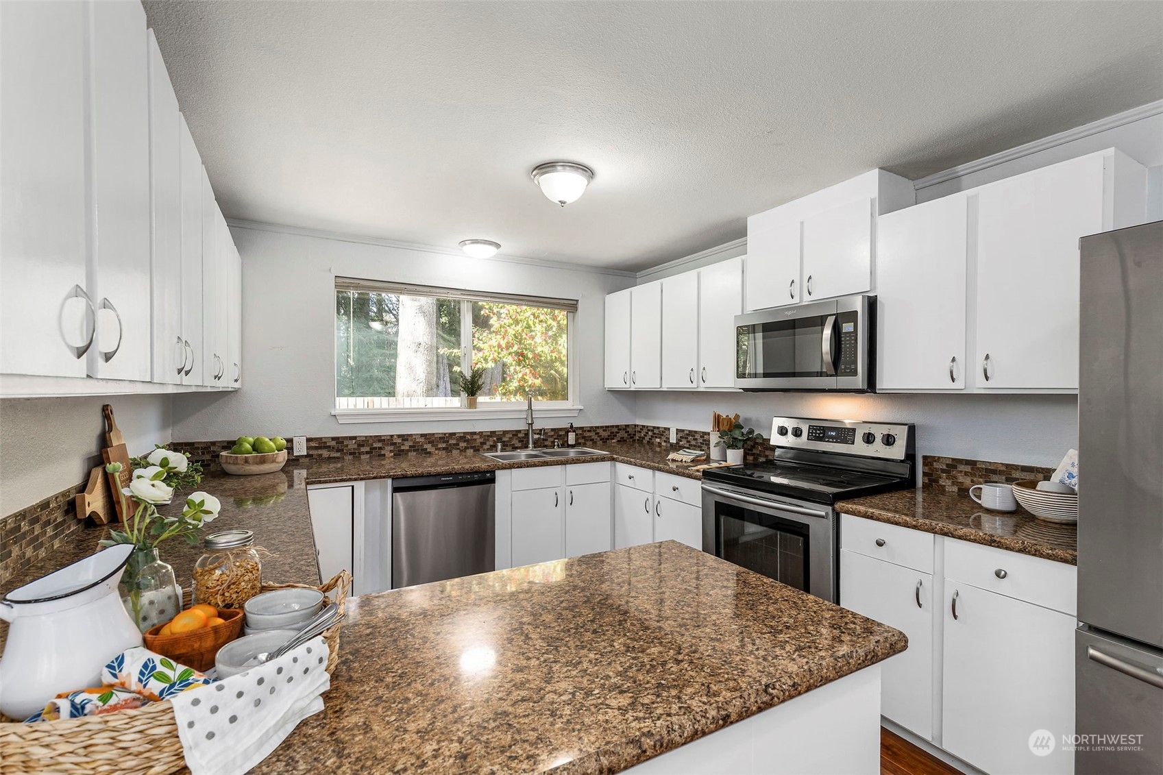 3741 Northeast Lincoln Road Poulsbo, WA 98370 - Photo 15 of 35 a kitchen with stainless steel appliances granite countertop a sink stove microwave and cabinets