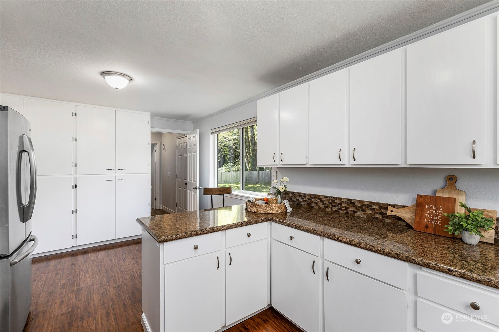 3741 Northeast Lincoln Road Poulsbo, WA 98370 - Photo 16 of 35 a kitchen with granite countertop white cabinets white appliances a sink and a stove