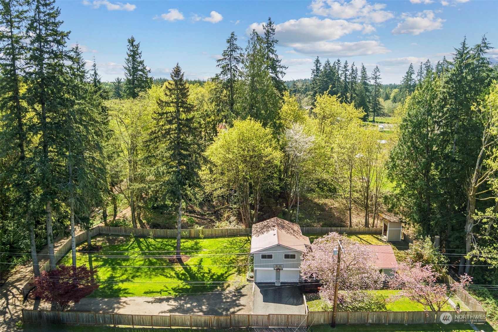 3741 Northeast Lincoln Road Poulsbo, WA 98370 - Photo 2 of 35 a view of a lake with a building in the background