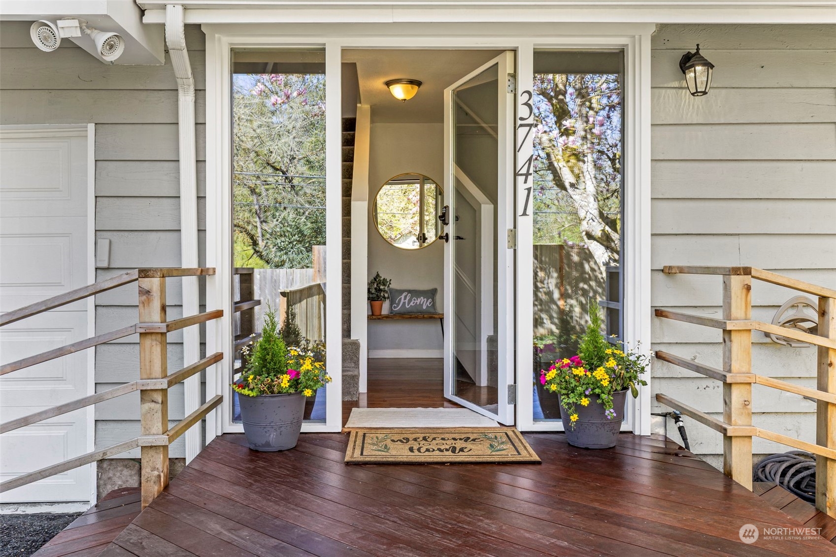 3741 Northeast Lincoln Road Poulsbo, WA 98370 - Photo 7 of 35 a front view of a house with wooden floor and a potted plant