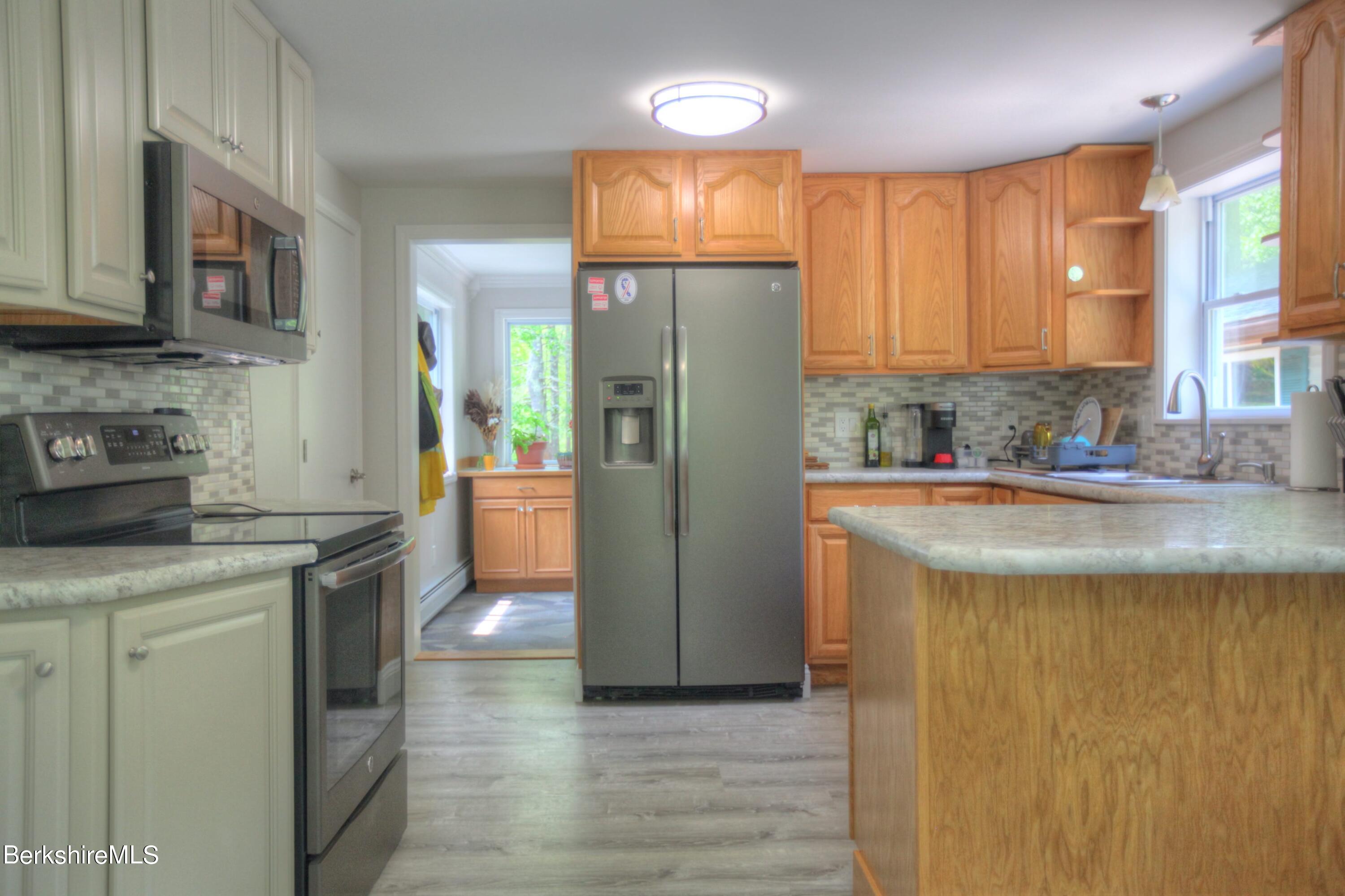 6 Roosterville Road Sandisfield, MA 01255 - Photo 14 of 35 a kitchen with stainless steel appliances granite countertop a refrigerator a stove and a sink