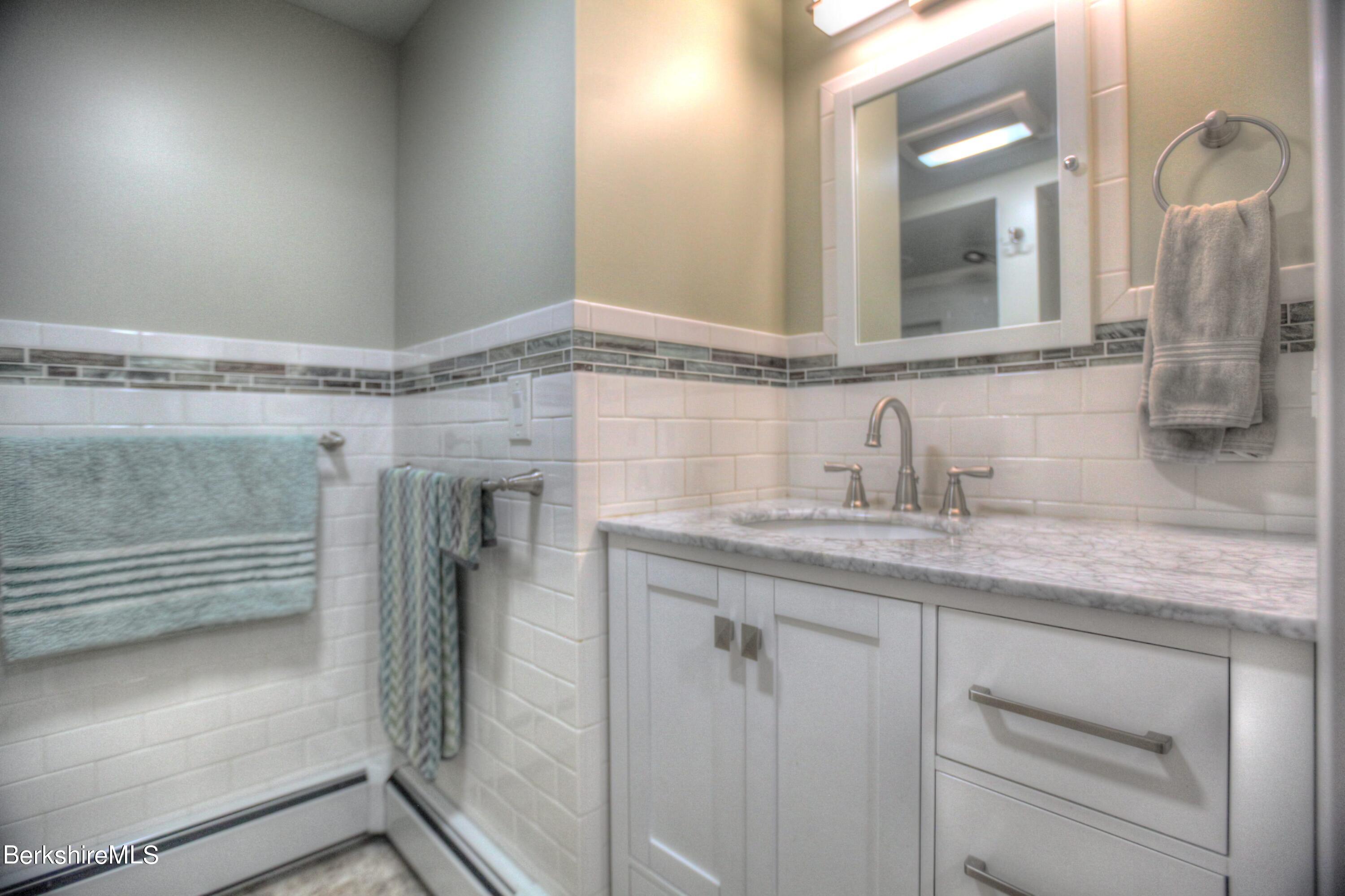 6 Roosterville Road Sandisfield, MA 01255 - Photo 18 of 35 a bathroom with a granite countertop sink and a mirror