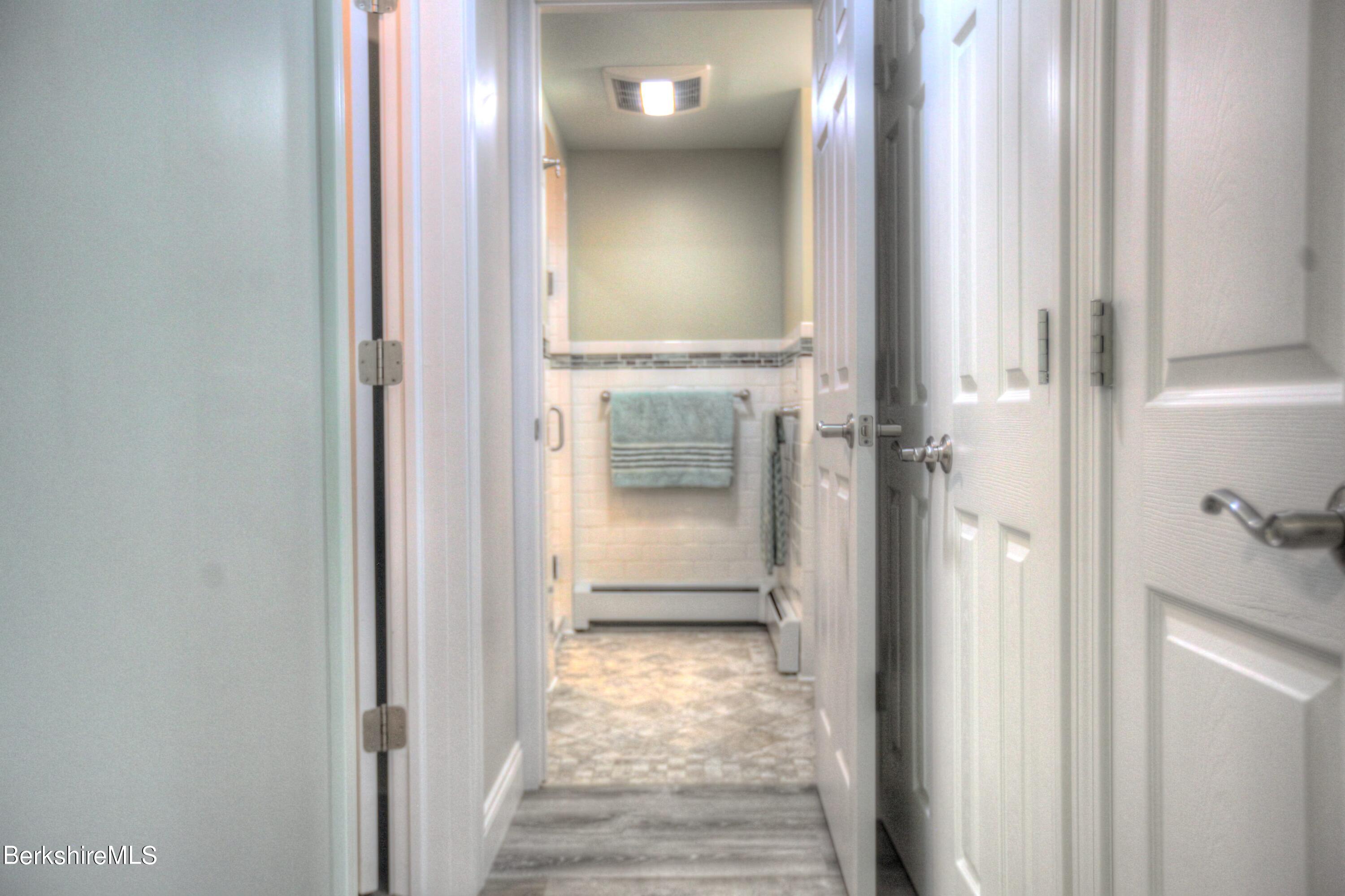 6 Roosterville Road Sandisfield, MA 01255 - Photo 23 of 35 a view of a hallway with wooden floor and a bathroom