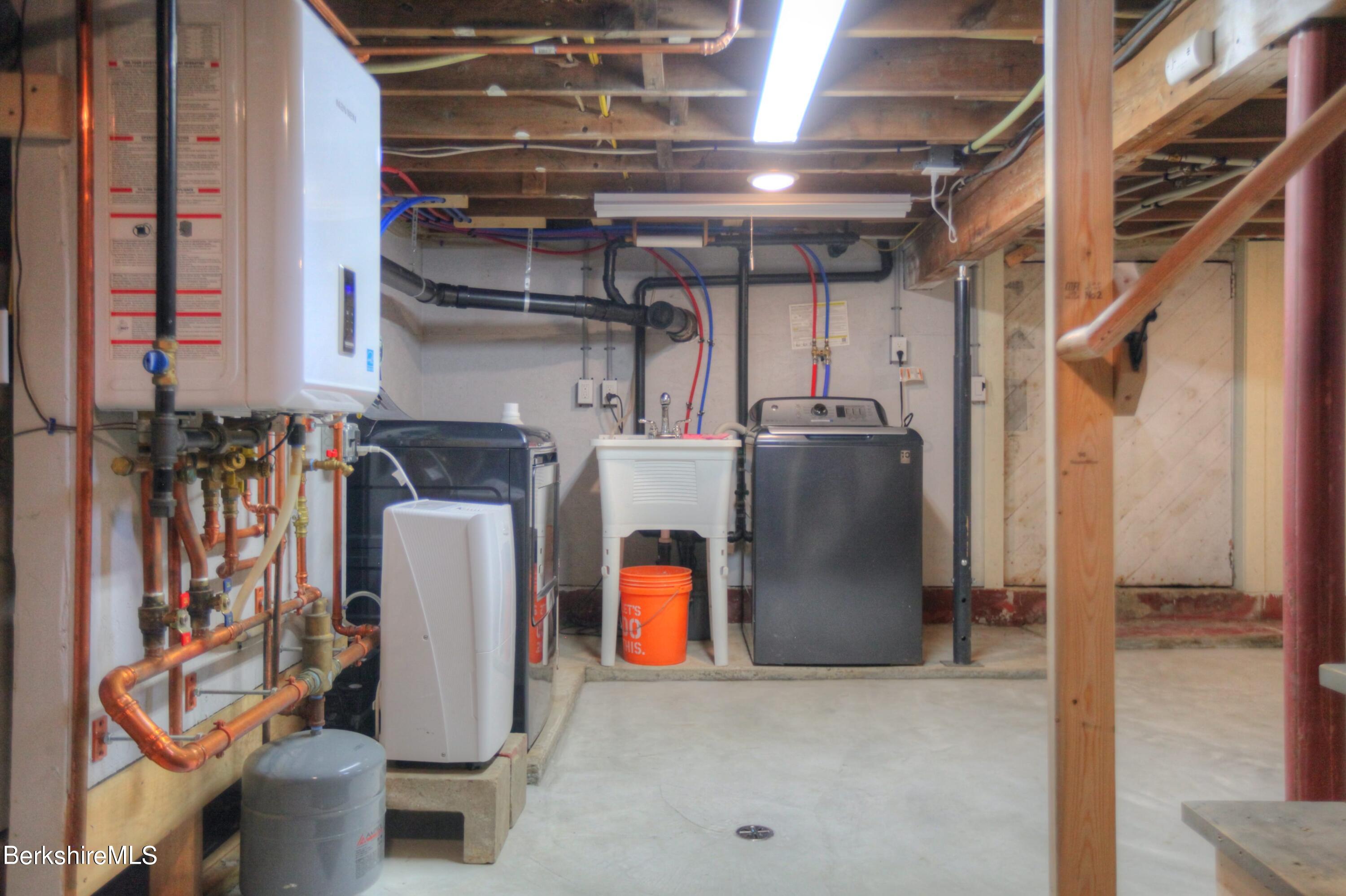 6 Roosterville Road Sandisfield, MA 01255 - Photo 24 of 35 a view of storage and utility room with refrigerator and washer