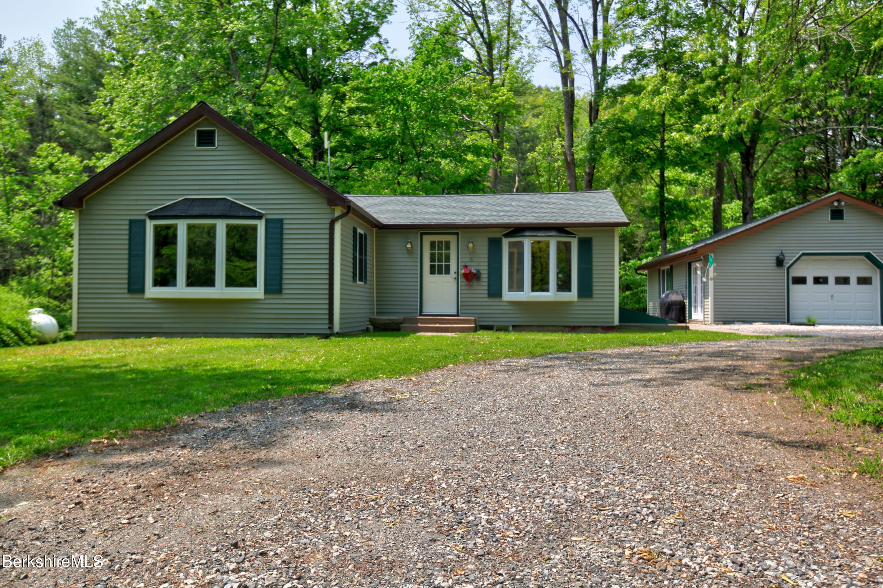 6 Roosterville Road Sandisfield, MA 01255 - Photo 8 of 35 a front view of a house with a garden and trees