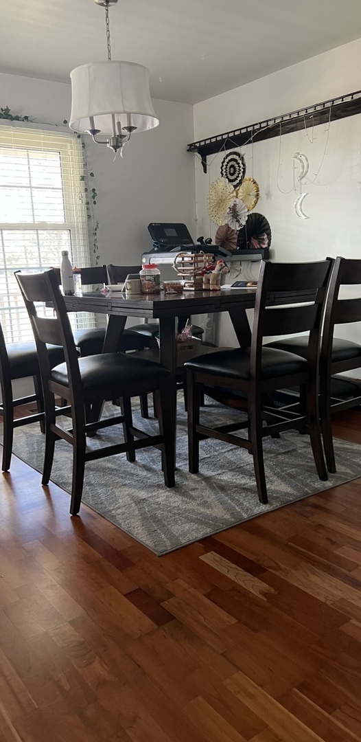Undisclosed Address Schaumburg, IL 60173 - Photo 4 of 8 a view of a dining room with furniture and chandelier