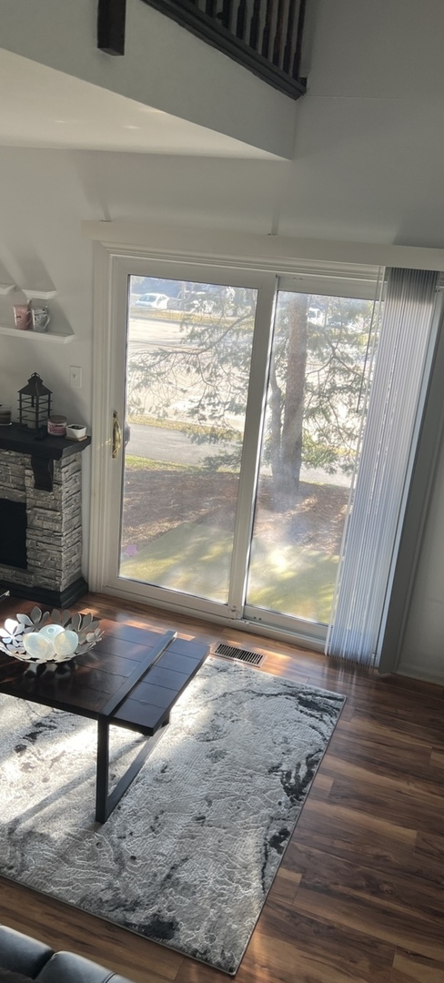 Undisclosed Address Schaumburg, IL 60173 - Photo 5 of 8 a view of a livingroom with wooden floor and a window