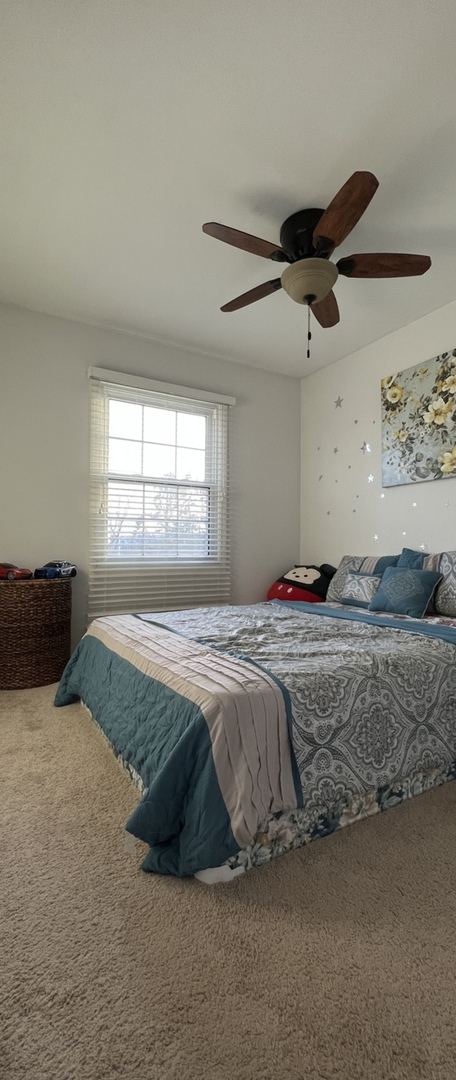 Undisclosed Address Schaumburg, IL 60173 - Photo 6 of 8 a bedroom with a bed and window