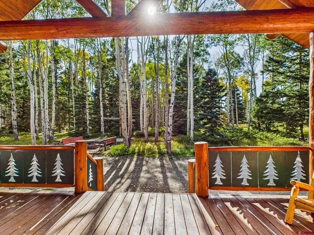 a view of balcony with wooden floor and outdoor seating