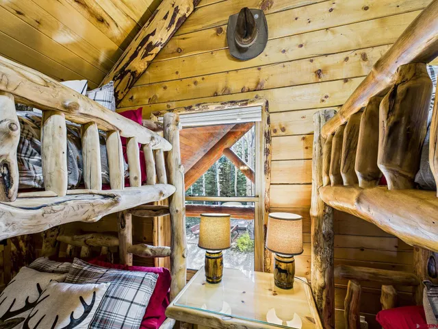 a view of a garden with plants and wooden fence