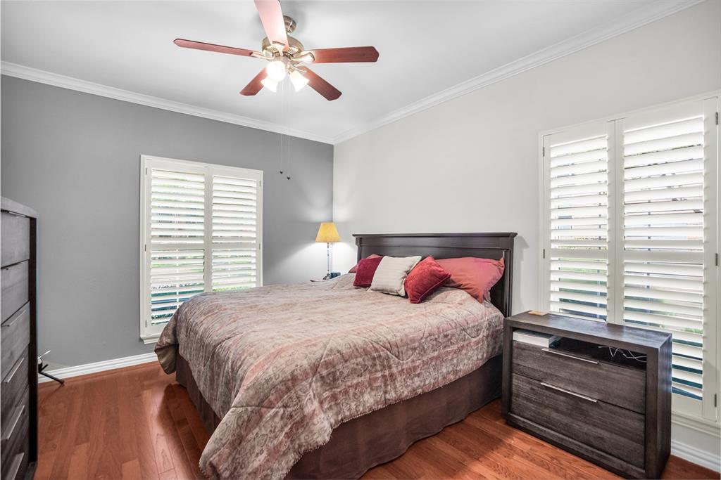 2524 Preston Road, Unit 808 Plano, TX 75093 - Photo 19 of 31 Primary bedroom with plantation shutters, hard wood floors and Ensuite bath.