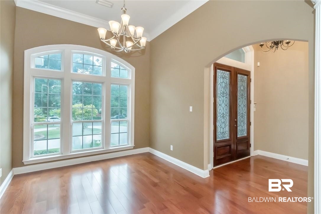 8837 Dawes Lake Road South Mobile, AL 36619 - Photo 5 of 44 Foyer with crown molding, vaulted ceiling, a chandelier, and hardwood / wood-style floors