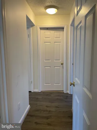 a view of room with wooden floor