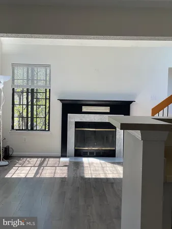 a living room with a fireplace and a window