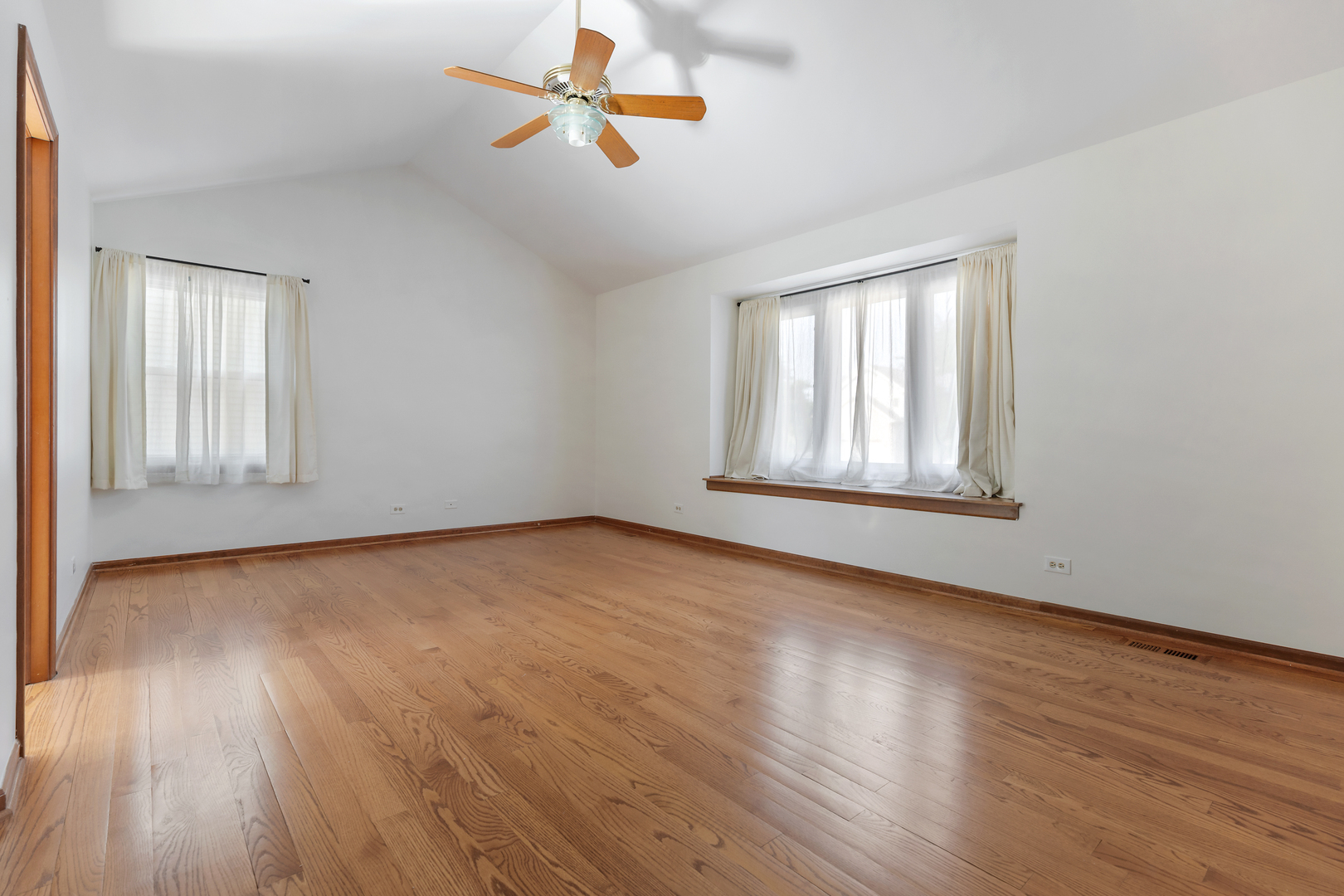 775 Harmon Boulevard Hoffman Estates, IL 60169 - Photo 10 of 27 an empty room with wooden floor ceiling fan and windows
