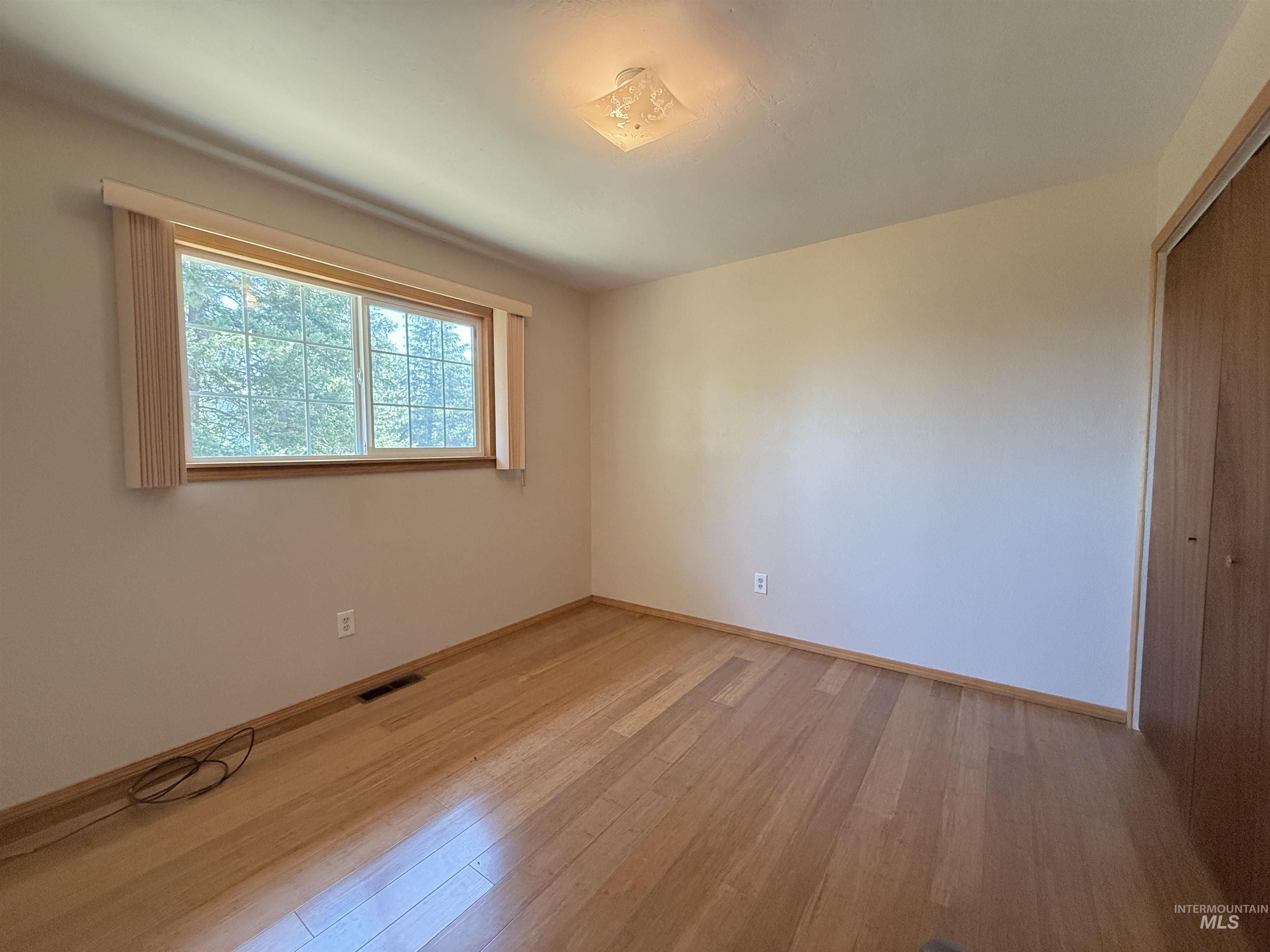 752 Mt Idaho Grade Road Grangeville, ID 83530 - Photo 11 of 29 Empty room featuring light wood-style flooring and baseboards