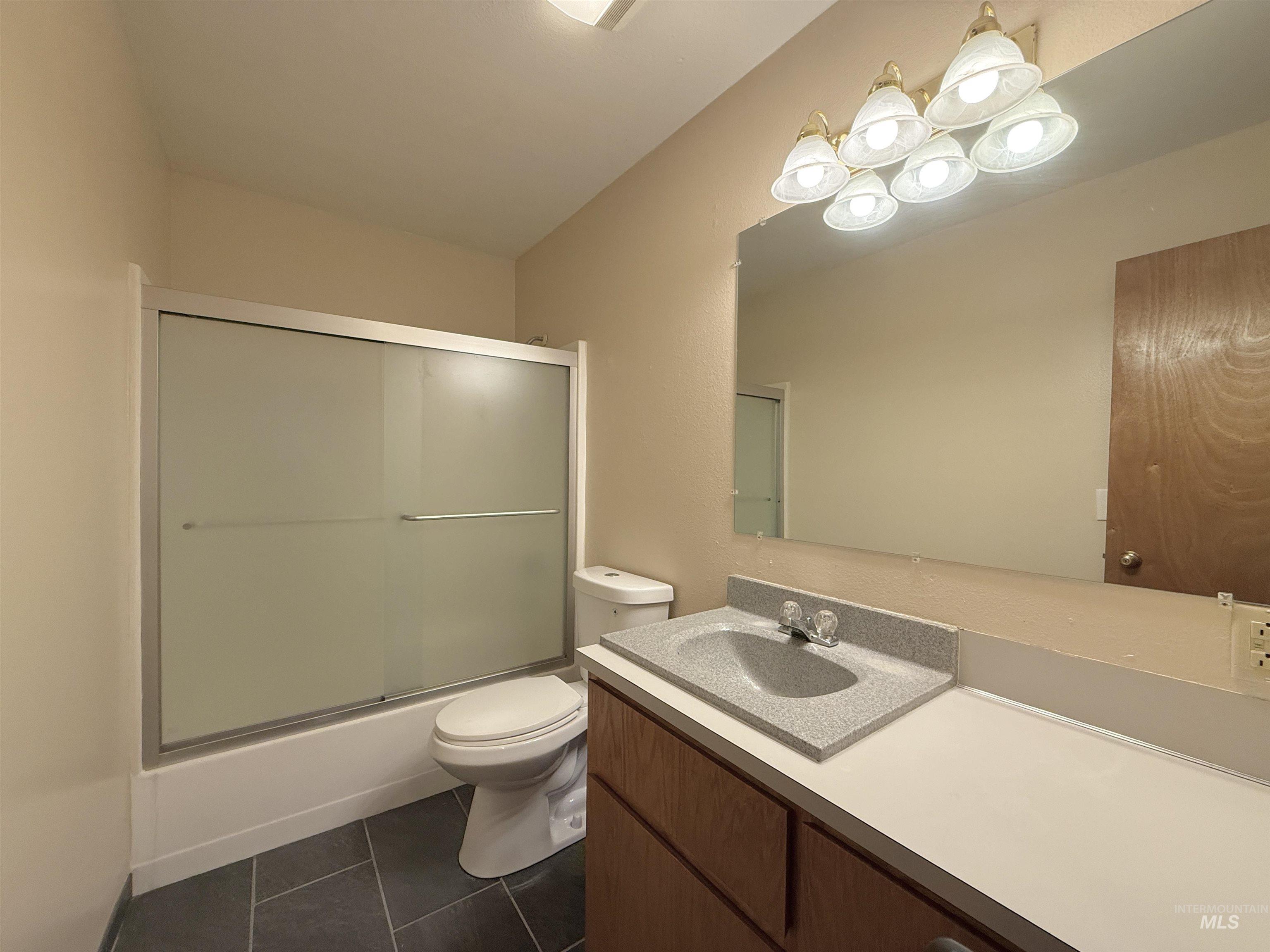 752 Mt Idaho Grade Road Grangeville, ID 83530 - Photo 8 of 29 Full bathroom with vanity, tile patterned floors, and enclosed tub / shower combo