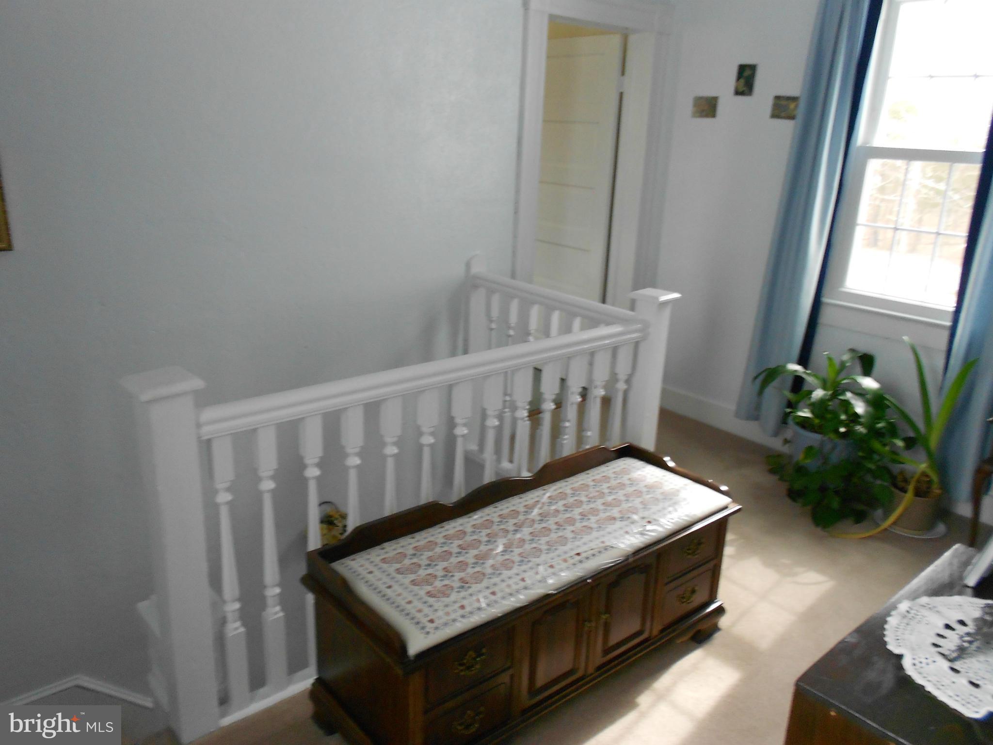 14191 Goldvein Road Goldvein, VA 22720 - Photo 14 of 27 a bedroom with furniture and a potted plant