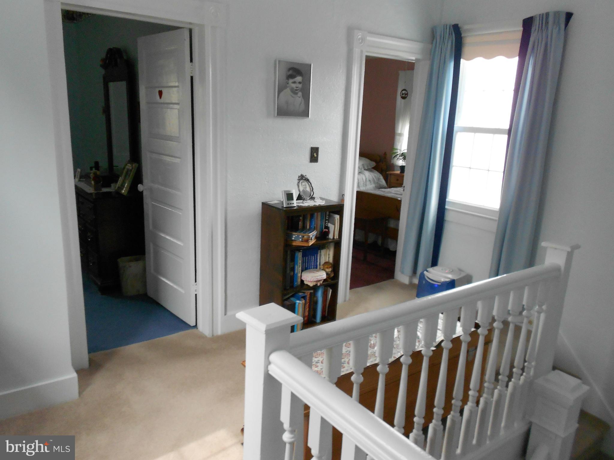 14191 Goldvein Road Goldvein, VA 22720 - Photo 15 of 27 a view of a hallway with wooden floor and stairs