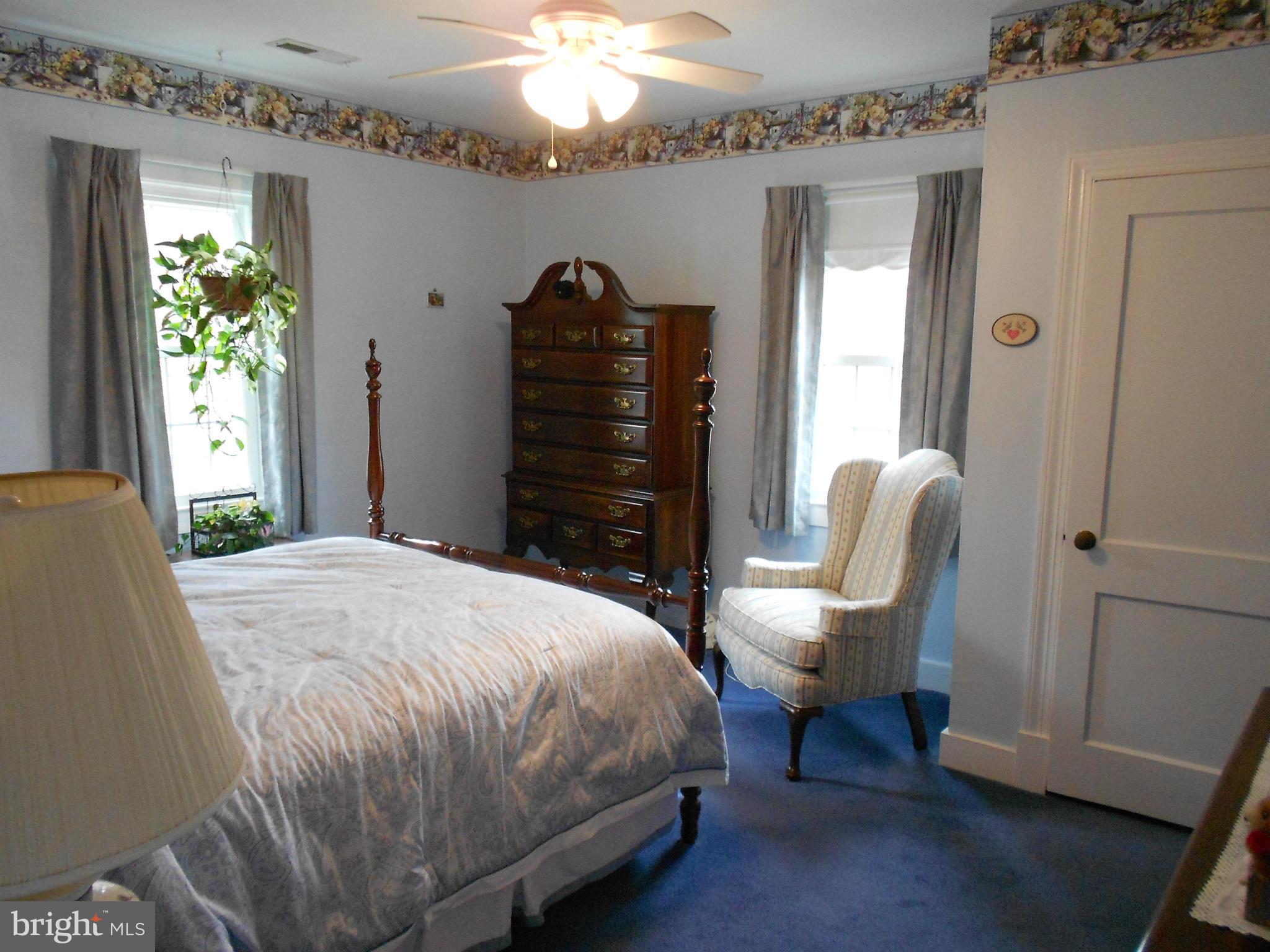 14191 Goldvein Road Goldvein, VA 22720 - Photo 16 of 27 a bedroom with a bed and a chandelier