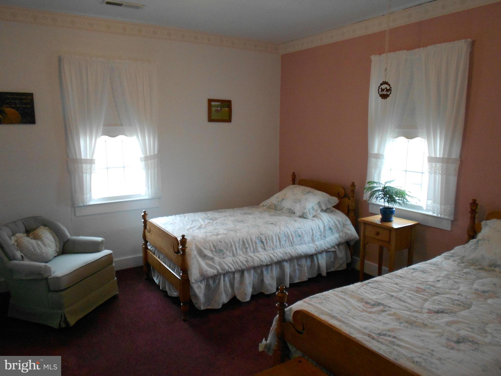 14191 Goldvein Road Goldvein, VA 22720 - Photo 17 of 27 a bedroom with two beds and a window