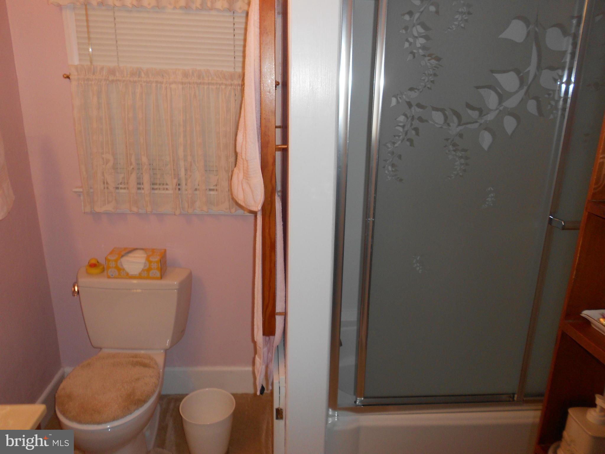 14191 Goldvein Road Goldvein, VA 22720 - Photo 19 of 27 a white toilet sitting next to a small bathroom