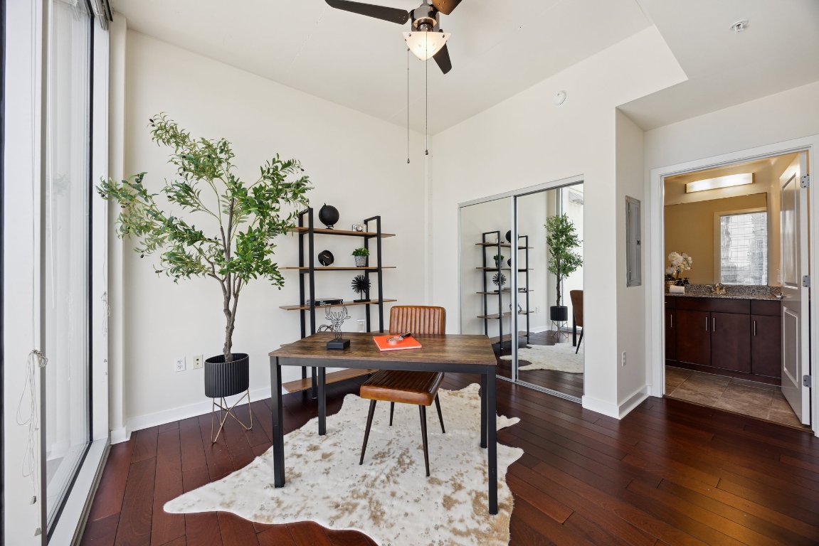 360 Nueces Street, Unit 1116 Austin, TX 78701 - Photo 11 of 33 a workspace with furniture and wooden floor