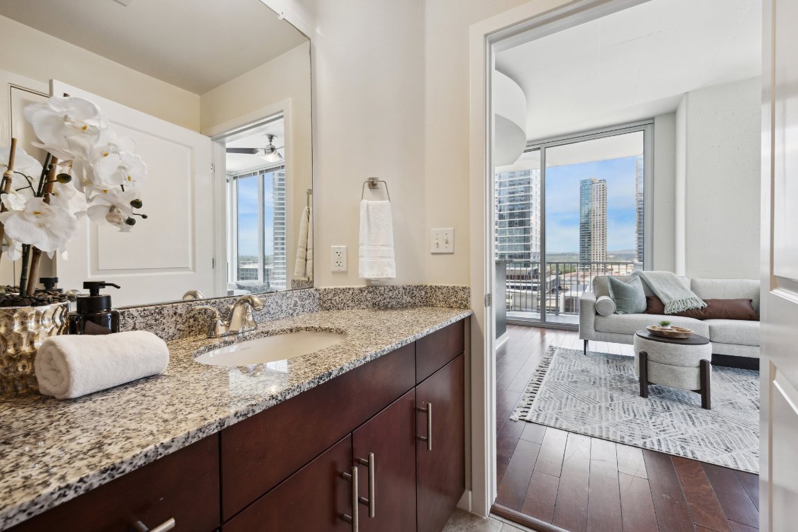 360 Nueces Street, Unit 1116 Austin, TX 78701 - Photo 13 of 33 a en suite bathroom with a granite countertop double vanity