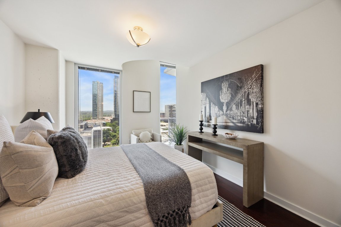 360 Nueces Street, Unit 1116 Austin, TX 78701 - Photo 15 of 33 a bedroom with a bed and wooden floor