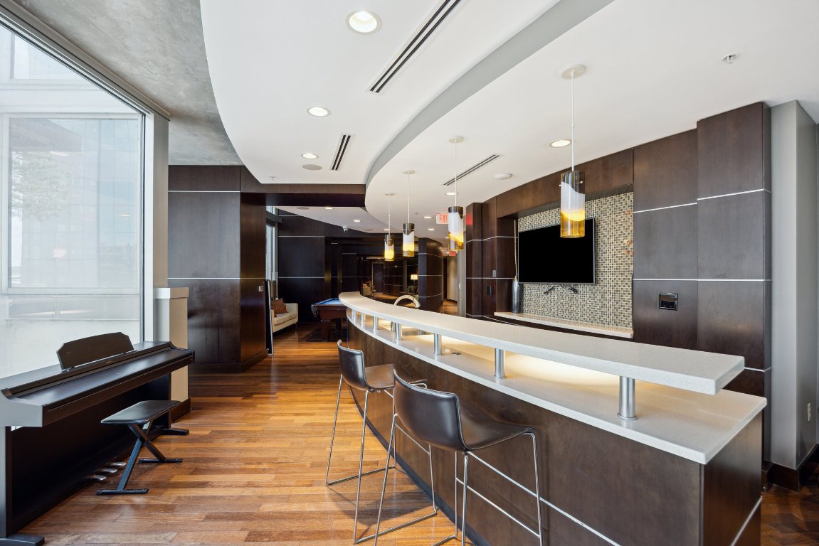 360 Nueces Street, Unit 1116 Austin, TX 78701 - Photo 27 of 33 a large kitchen with a large counter top furniture and appliances