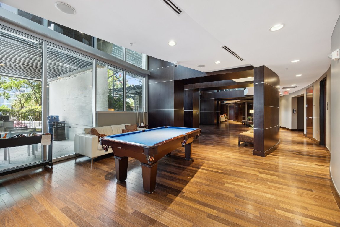 360 Nueces Street, Unit 1116 Austin, TX 78701 - Photo 28 of 33 a living room with furniture a table and chairs