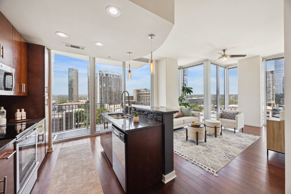 360 Nueces Street, Unit 1116 Austin, TX 78701 - Photo 4 of 33 a living room with furniture large windows and wooden floor