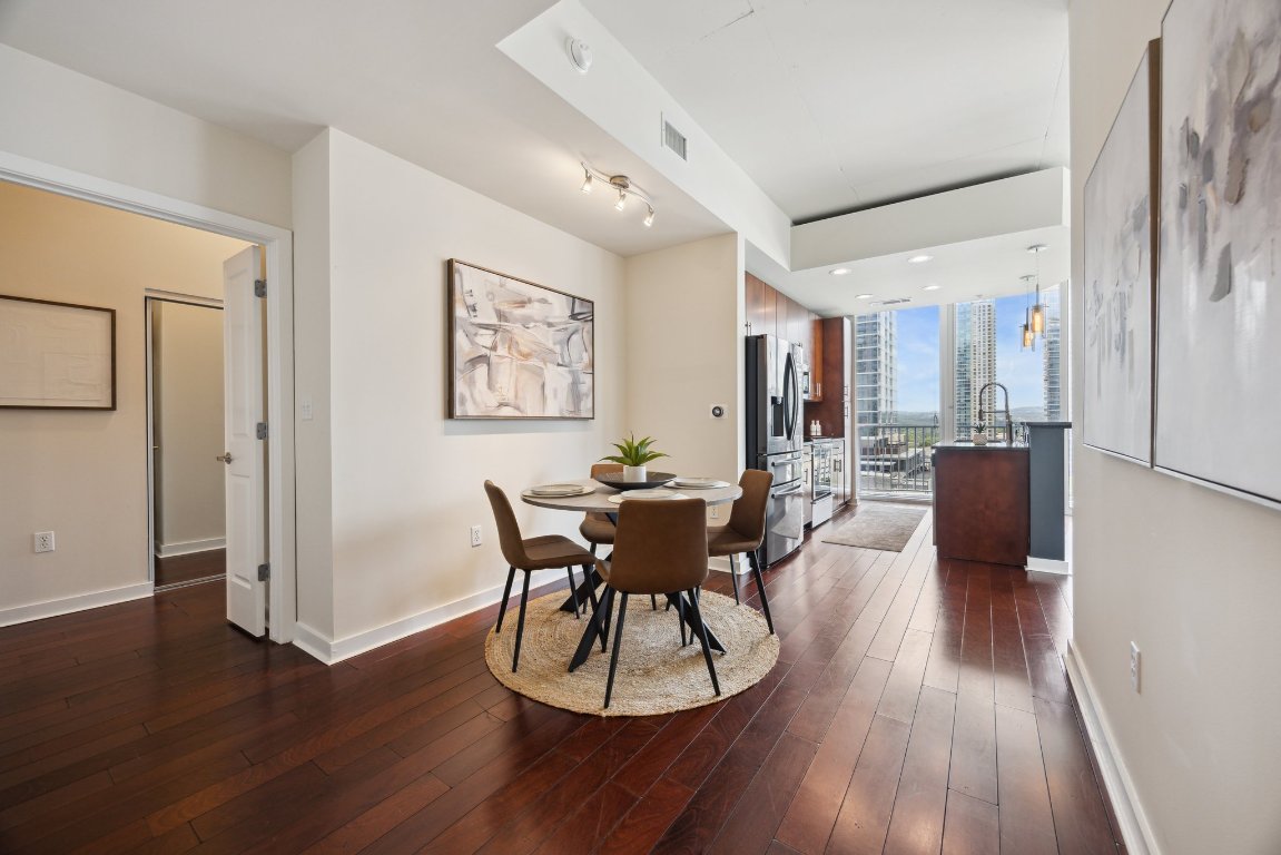 360 Nueces Street, Unit 1116 Austin, TX 78701 - Photo 6 of 33 a view of a dining room with furniture and wooden floor