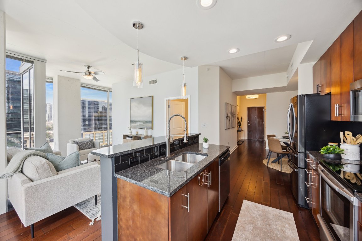 360 Nueces Street, Unit 1116 Austin, TX 78701 - Photo 33 of 33 a kitchen with stainless steel appliances granite countertop a sink a stove and a refrigerator